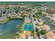 Aerial view of waterfront community with pool, tennis courts, and canal with boat docks at 4316 Sunray Ct # 34, Tampa, FL 33615