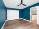 Bedroom has wood-look floors, teal walls, and a closet with bi-fold doors at 4316 Sunray Ct # 34, Tampa, FL 33615