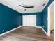 Bedroom has wood-look floors, teal walls, closet, and access to the staircase at 4316 Sunray Ct # 34, Tampa, FL 33615