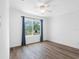 Bright bedroom features wood-look floors, ceiling fan and a large window with a view at 4316 Sunray Ct # 34, Tampa, FL 33615