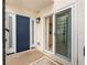 Inviting entryway with a blue front door, sliding glass doors, and brick pavers, creating a welcoming entrance at 4316 Sunray Ct # 34, Tampa, FL 33615