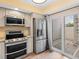 Modern kitchen featuring stainless steel appliances and granite countertops, adjacent to a sliding glass door at 4316 Sunray Ct # 34, Tampa, FL 33615