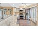Modern kitchen features white cabinets, granite countertops, stainless steel appliances, and wood-look floors at 4316 Sunray Ct # 34, Tampa, FL 33615