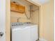 A compact laundry room with a washer and dryer, storage cabinets, and shelving, providing efficient laundry solutions at 4316 Sunray Ct # 34, Tampa, FL 33615