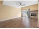 Open living room with luxury vinyl plank flooring, ceiling fan, fireplace and sliding doors at 4316 Sunray Ct # 34, Tampa, FL 33615