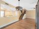 Open-concept living room with wood floors, stairs and adjacent kitchen and countertop with modern finishes at 4316 Sunray Ct # 34, Tampa, FL 33615