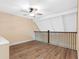 Spacious loft area features wood flooring, high ceilings, and railing with views of the main living area at 4316 Sunray Ct # 34, Tampa, FL 33615