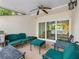 Relaxing outdoor porch with dark green seating and ceiling fan, perfect for enjoying the weather at 4316 Sunray Ct # 34, Tampa, FL 33615