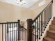 Elegant staircase with dark railings leading to a cozy living area with a fireplace and outdoor seating at 4316 Sunray Ct # 34, Tampa, FL 33615
