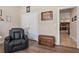 A bedroom featuring laminate flooring and a comfortable looking reclining chair at 4839 Pointe O Woods Dr, Wesley Chapel, FL 33543