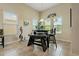 Well-lit dining area with large windows, bench seating, and a unique wine rack at 4839 Pointe O Woods Dr, Wesley Chapel, FL 33543