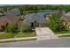 Charming single-Gathering home with a three-car garage, landscaped yard and a long driveway at 4839 Pointe O Woods Dr, Wesley Chapel, FL 33543