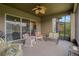 Relaxing covered patio with comfortable seating and a ceiling fan at 4839 Pointe O Woods Dr, Wesley Chapel, FL 33543