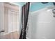 Clean bathroom with a shower/tub combo, a dark curtain, and white-painted doors at 5050 68Th N Way, St Petersburg, FL 33709