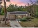 Charming home featuring solar panels, a screened-in porch, and a well-manicured lawn at 5050 68Th N Way, St Petersburg, FL 33709