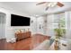 Bright living room with hardwood floors, a large TV, and an inviting front door at 5050 68Th N Way, St Petersburg, FL 33709