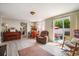 Comfortable living room with a piano and sitting area leading to a backyard patio at 5050 68Th N Way, St Petersburg, FL 33709