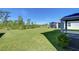 Lawn extends to wooded backdrop at 5325 Thistle Field Ct, Wesley Chapel, FL 33545