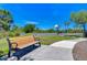 Community park view featuring a basketball court, bench, mature trees, and landscaping at 5325 Thistle Field Ct, Wesley Chapel, FL 33545