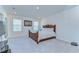 Spacious bedroom featuring a bed with a decorative headboard and a media center for entertainment at 5325 Thistle Field Ct, Wesley Chapel, FL 33545