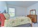 Bedroom with a decorative metal bed frame and natural wood dresser at 5325 Thistle Field Ct, Wesley Chapel, FL 33545