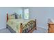 Bright bedroom with an iron bed frame and wooden nightstand at 5325 Thistle Field Ct, Wesley Chapel, FL 33545