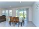 Bright dining area with sliding glass doors leading to the outdoors, perfect for entertaining at 5325 Thistle Field Ct, Wesley Chapel, FL 33545