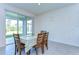 Cozy dining area with a table set for four, adjacent to sliding glass doors leading to the backyard at 5325 Thistle Field Ct, Wesley Chapel, FL 33545