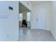 Inviting entryway with tile flooring, a smart home system, and a view into the bright, open living area at 5325 Thistle Field Ct, Wesley Chapel, FL 33545