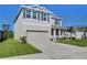 Two-story home with a two car garage, manicured lawn, and complemented by a sunny blue sky at 5325 Thistle Field Ct, Wesley Chapel, FL 33545