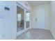 Bright foyer featuring tile flooring, a white door, and glass french doors at 5325 Thistle Field Ct, Wesley Chapel, FL 33545