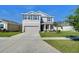 A charming two-story home with a well-manicured lawn, a two car garage, and delightful curb appeal at 5325 Thistle Field Ct, Wesley Chapel, FL 33545
