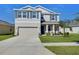 Charming two-story home featuring a well-kept lawn, two-car garage, and inviting curb appeal at 5325 Thistle Field Ct, Wesley Chapel, FL 33545