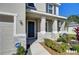Inviting front porch with stone accents, lush landscaping, and elegant entryway design at 5325 Thistle Field Ct, Wesley Chapel, FL 33545