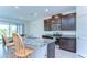 Bright kitchen featuring stainless steel appliances, granite countertops, and an island with bar stool seating at 5325 Thistle Field Ct, Wesley Chapel, FL 33545