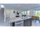 Spacious kitchen island with granite countertops and stainless steel appliances, perfect for meal prep and entertaining at 5325 Thistle Field Ct, Wesley Chapel, FL 33545
