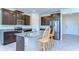 Modern kitchen featuring stainless steel appliances, granite countertops, and a center island with bar seating at 5325 Thistle Field Ct, Wesley Chapel, FL 33545