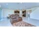 Spacious open-plan living area with tile floors, a cozy seating arrangement, and integrated kitchen at 5325 Thistle Field Ct, Wesley Chapel, FL 33545