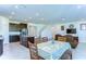 Open-concept living space includes kitchen, dining area, and living room with comfortable seating and natural light at 5325 Thistle Field Ct, Wesley Chapel, FL 33545
