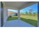 View from the covered patio, showing a spacious backyard, lush lawn, and serene wooded backdrop at 5325 Thistle Field Ct, Wesley Chapel, FL 33545