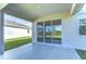Covered patio boasts neutral tones, recessed lights, and a serene backyard view, perfect for outdoor relaxation at 5325 Thistle Field Ct, Wesley Chapel, FL 33545