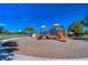 Community playground with slides, climbing structures, and benches near a basketball court at 5325 Thistle Field Ct, Wesley Chapel, FL 33545