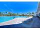 Resort-style pool features lounge chairs, palm trees, and clear blue water for luxurious relaxation at 5325 Thistle Field Ct, Wesley Chapel, FL 33545