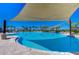 Expansive community pool with ample sun shade, inviting residents to relax and enjoy the outdoors at 5325 Thistle Field Ct, Wesley Chapel, FL 33545