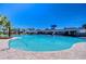 This pool features a clear blue water, shaded seating, and easy access with multiple entry points at 5325 Thistle Field Ct, Wesley Chapel, FL 33545