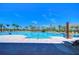 Beautiful community pool with ample lounging chairs and sun shades, creating an oasis for residents at 5325 Thistle Field Ct, Wesley Chapel, FL 33545
