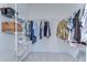 Organized walk-in closet featuring shelving units and hanging rods for clothing storage at 5325 Thistle Field Ct, Wesley Chapel, FL 33545