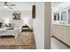 Bright bedroom featuring modern decor, tiled floors, ceiling fan and an adjacent bathroom area at 5950 Pelican Bay S Plz # 603, Gulfport, FL 33707
