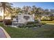 Beautiful stone sign for Pasadena Yacht & Country Club with colorful flower beds and well-maintained landscaping at 5950 Pelican Bay S Plz # 603, Gulfport, FL 33707