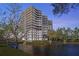 Waterfront high-rise condominium featuring multiple balconies, offering scenic views at 5950 Pelican Bay S Plz # 603, Gulfport, FL 33707